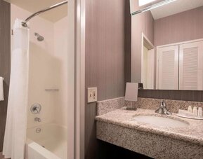 Private guest bathroom with shower and free toiletries at Sonesta Select Tempe Downtown.