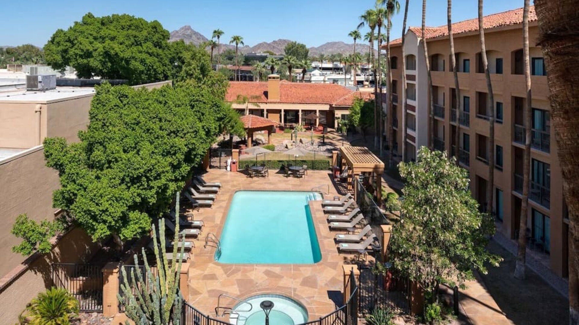 Outdoor pool with lounge seating at Sonesta Select Phoenix Camelback.