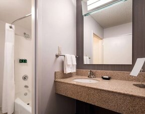 Private guest bathroom with shower and free toiletries at Sonesta Select Los Angeles LAX El Segundo.