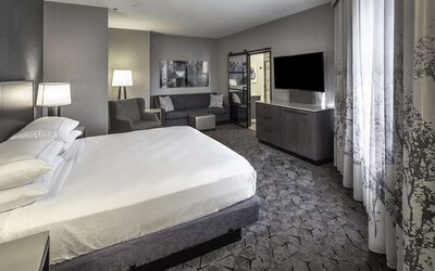 King size bed and sofa in a day use room at DoubleTree By Hilton Modesto.
