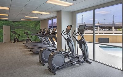 Fitness center with a view of the pool at DoubleTree By Hilton Modesto.