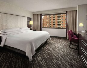King bedroom with work desk at Embassy Suites By Hilton Crystal City-National Airport.