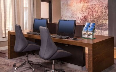 Business center with computers, printer and ergonomic chairs at Sonesta Select Columbia.