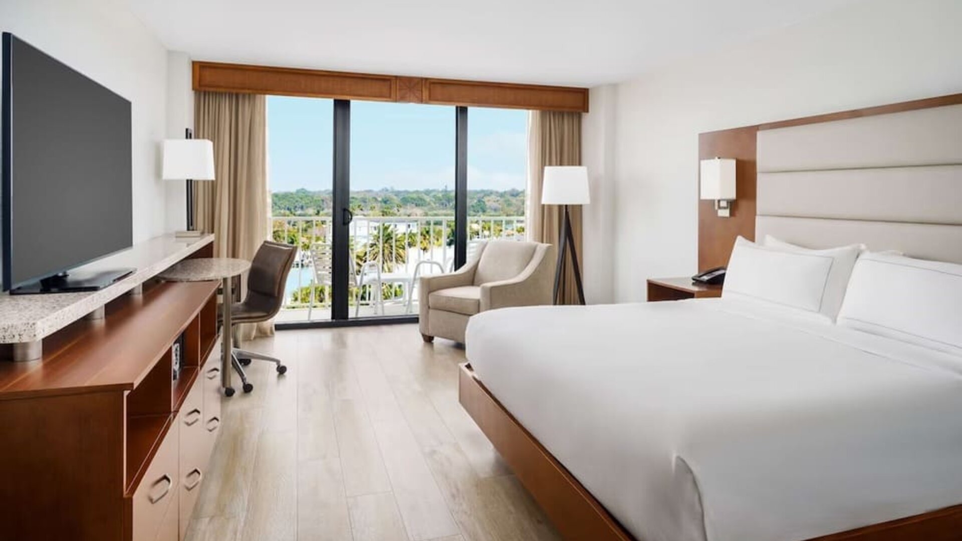 King size bed, work desk and balcony at DoubleTree Beach Resort By Hilton Tampa Bay - North Redington.