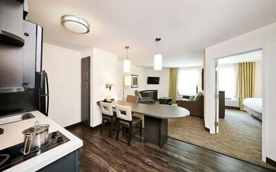 Day use suite with in-room kitchen, living area and private bathroom at Sonesta Simply Suites Plano Frisco.