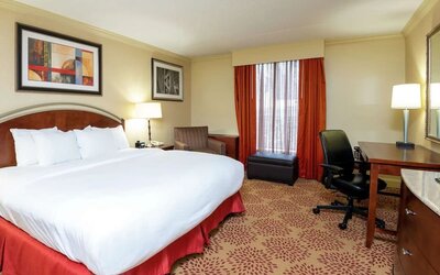 Work desk and sofa in a king bedroom at DoubleTree By Hilton Grand Rapids Airport.