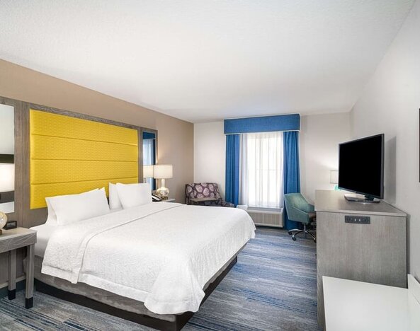 King size bed with work desk at Hampton Inn & Suites Amelia Island-Historic Harbor Front.