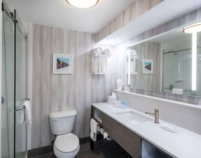 Guest bathroom with shower at Hampton Inn & Suites Amelia Island-Historic Harbor Front.