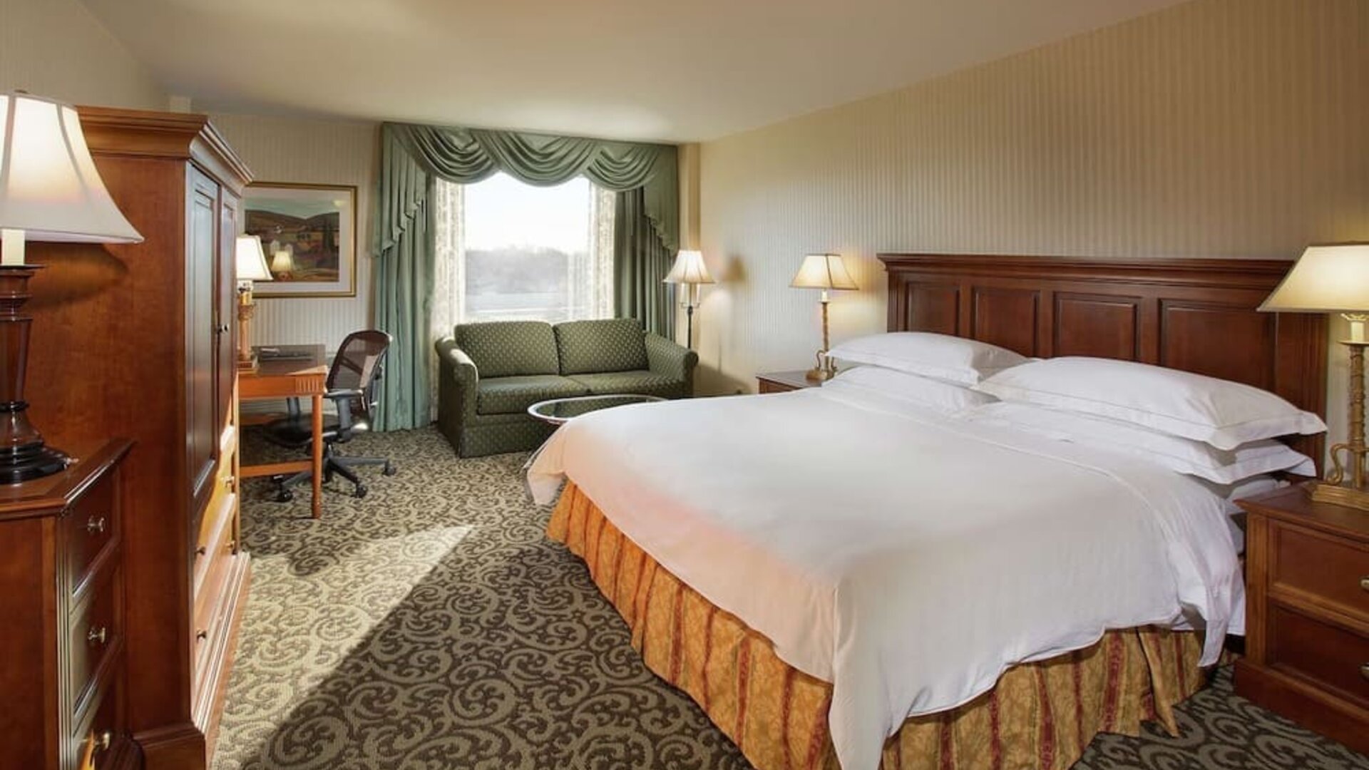 Spacious king room with king size bed, sofa and work desk at DoubleTree By Hilton Lisle-Naperville.