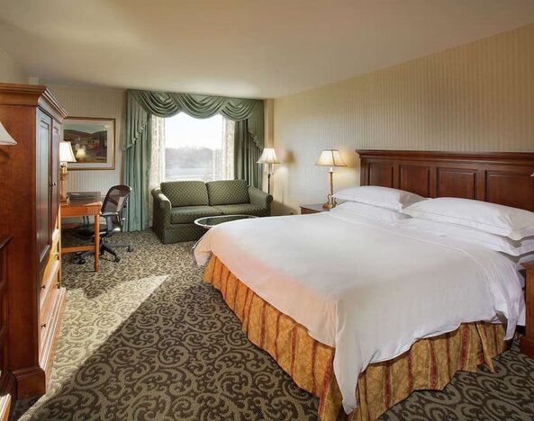 Spacious king room with king size bed, sofa and work desk at DoubleTree By Hilton Lisle-Naperville.