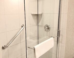 Guest bathroom with shower at DoubleTree By Hilton Lisle-Naperville.