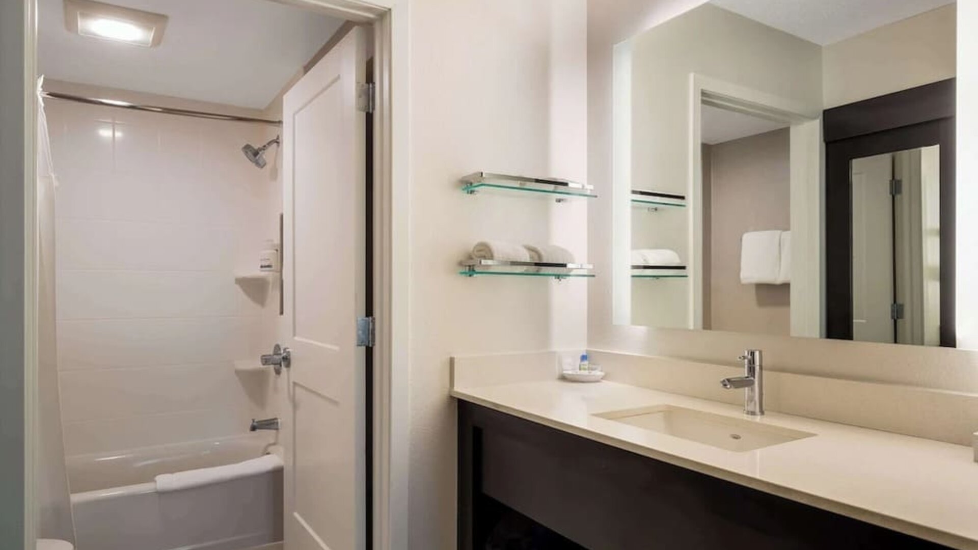Private guest bathroom with combined shower and tub at Sonesta ES Suites Parsippany Morris Plains.
