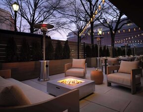 Patio with lounge seating and fire pit at Sonesta White Plains Downtown.