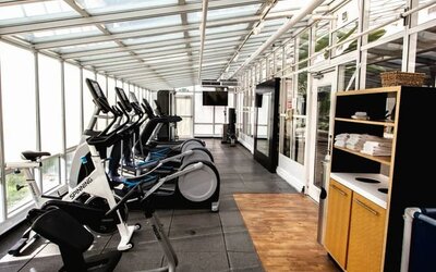 Fitness center with natural light at Embassy Suites By Hilton San Francisco Airport Waterfront.