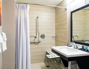 Accessible private guest bathroom with shower at Sonesta Atlanta Airport North.