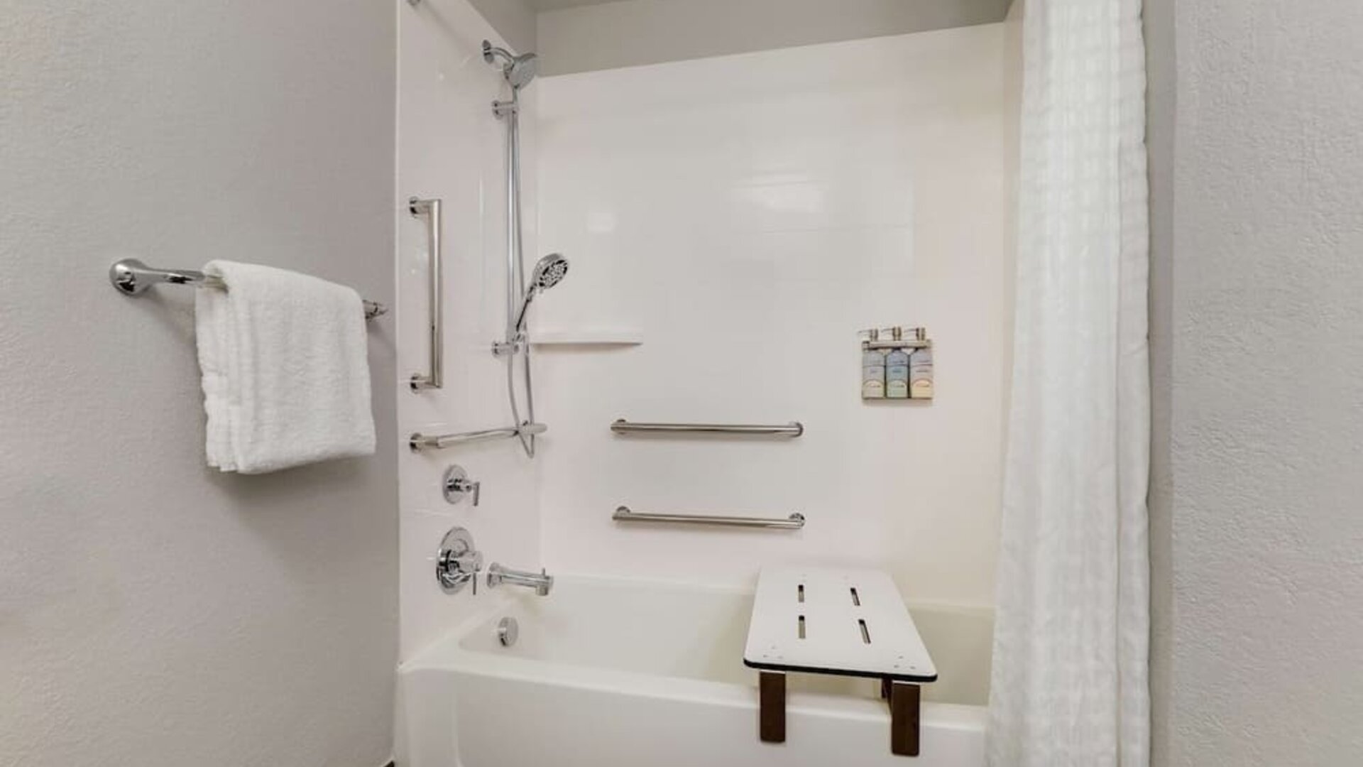 Accessible private bathroom with shower at Sonesta Simply Suites Miami Airport Doral.