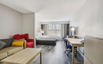 Day use room with work desk and living area at Country Inn & Suites By Radisson, Chicago O'Hare South.