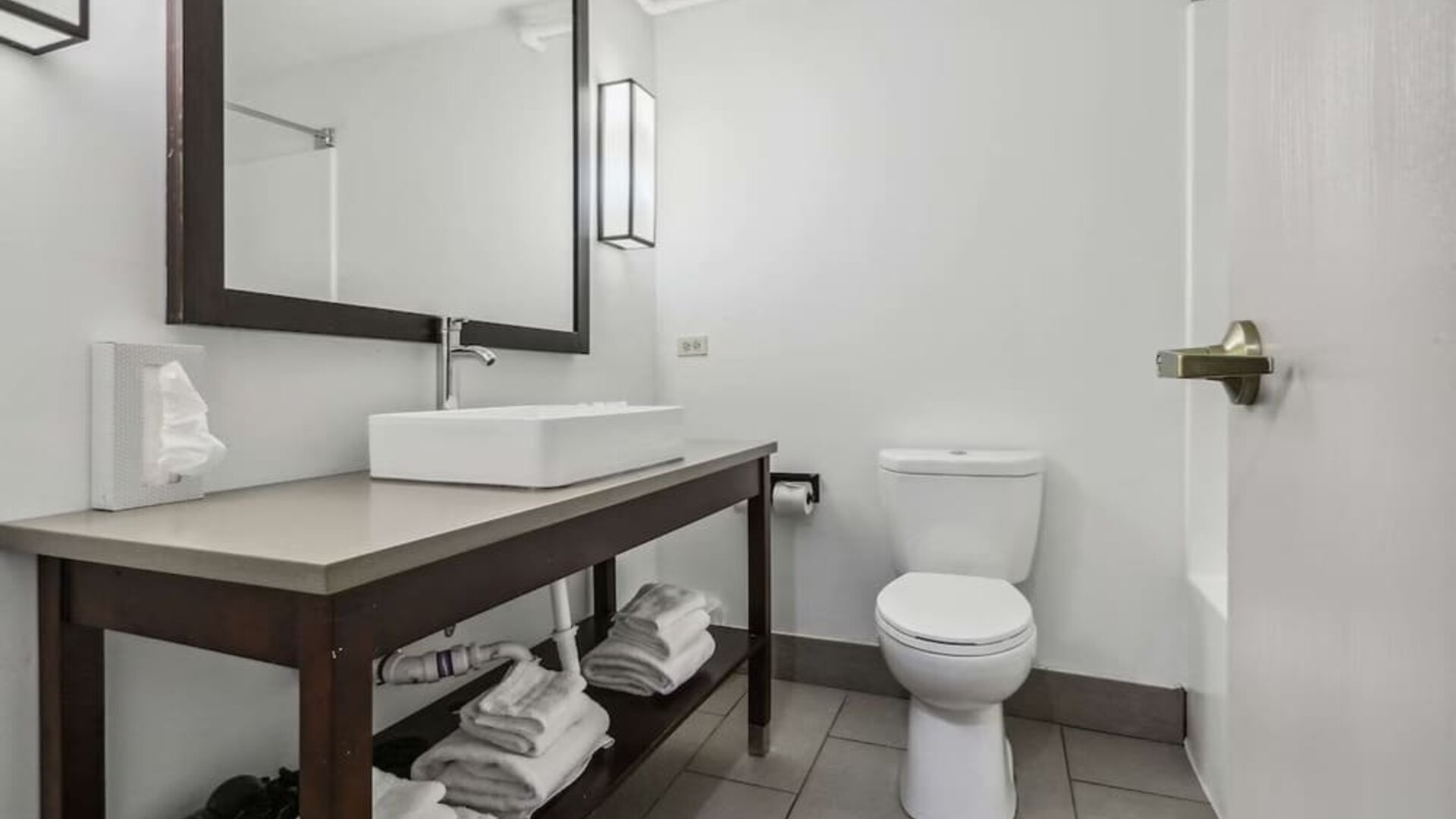 Private guest bathroom with shower and free toiletries at Country Inn & Suites By Radisson, Chicago O'Hare South.