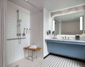 Accessible guest bathroom with shower at Sonesta Los Angeles Airport LAX.