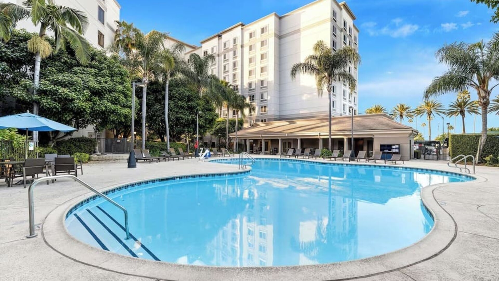 Outdoor pool with lounge area at Sonesta Anaheim Resort Area.