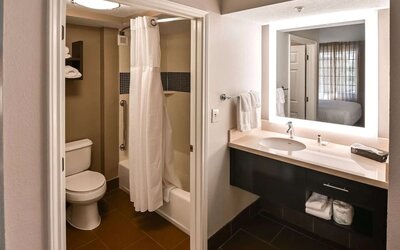 Private guest bathroom with combined shower and tub at Sonesta ES Suites San Antonio Northwest - Medical Center.