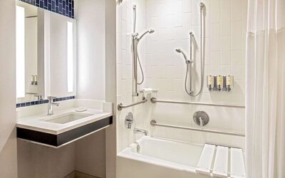 Private guest bathroom with combined shower and tub at Royal Sonesta Boston.
