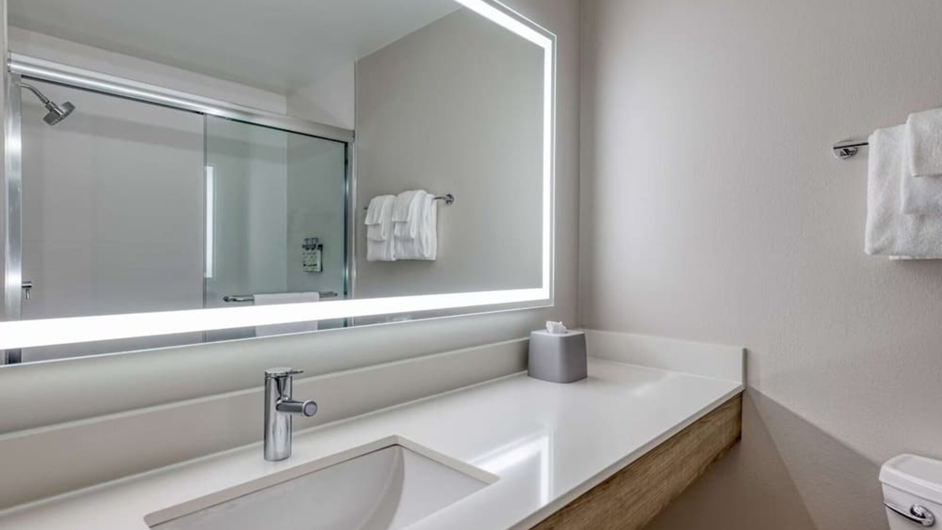 Private guest bathroom with shower and free toiletries at Holiday Inn Express & Suites Bensenville - O'Hare.