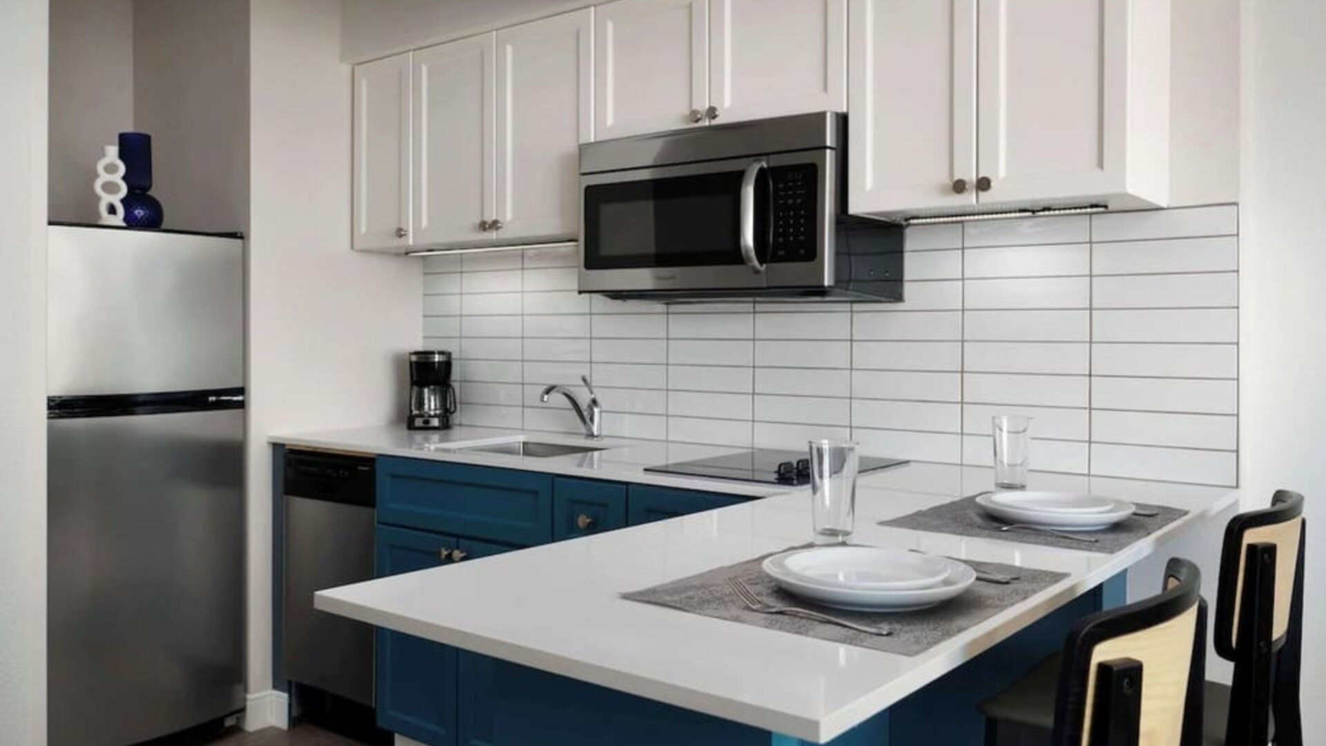 In-room kitchen, equipped with microwave, fridge, sink and breakfast bar at Sonesta ES Suites Chicago Downtown Magnificent Mile - Medical.