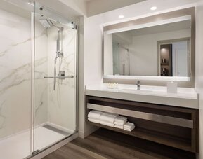Private guest bathroom with shower and free toiletries at Royal Sonesta Kaua'i Resort Lihue.
