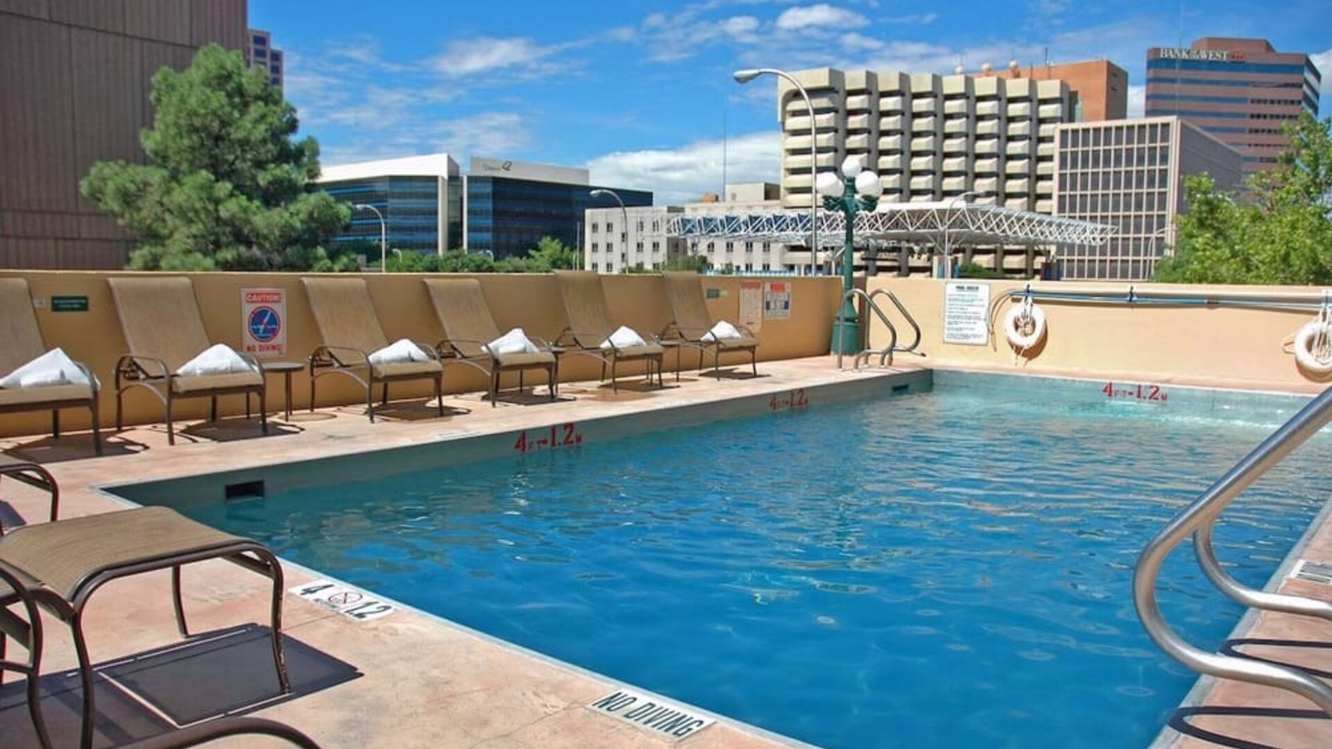 Refreshing outdoor pool surrounded by sunbeds at DoubleTree By Hilton Albuquerque.