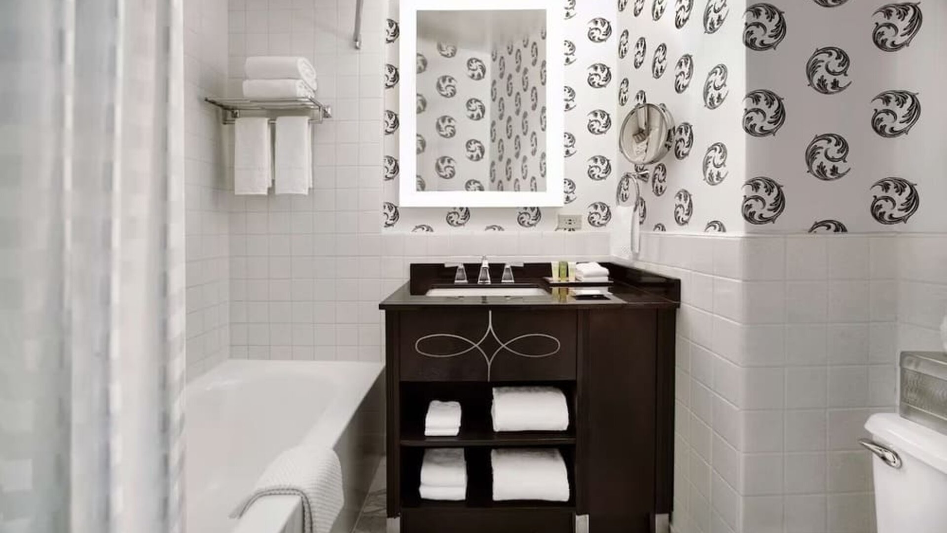 Guest bathroom with shower and tub at Palmer House A Hilton Hotel.