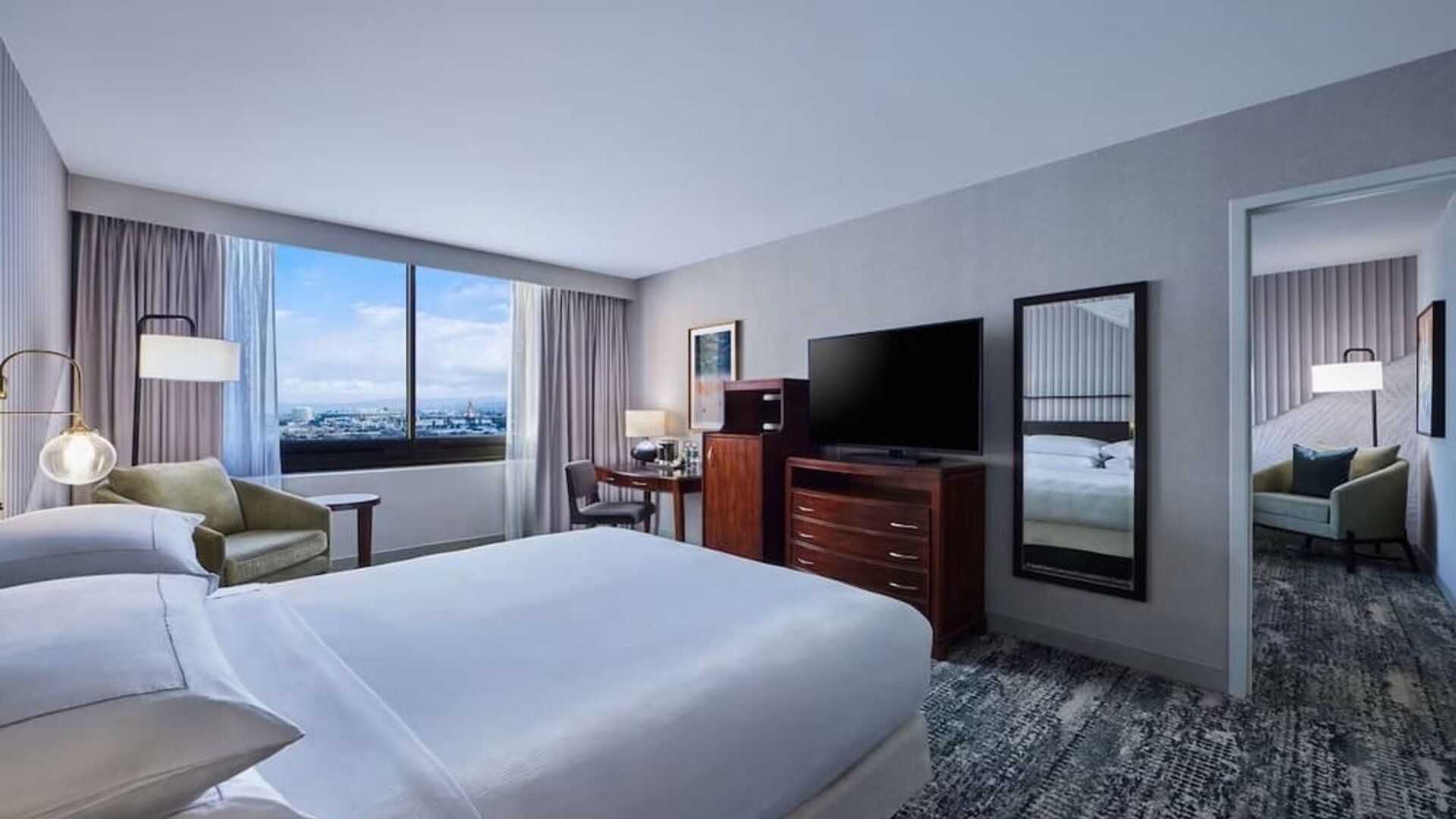 Day use room with work desk and living area at Hotel Fera Anaheim, A DoubleTree By Hilton.