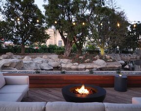 Firepit surrounded by comfortable chairs at Hotel Fera Anaheim, A DoubleTree By Hilton.