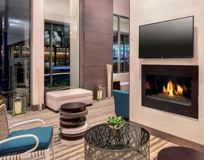 Comfortable lobby workspace by the fireplace at Hilton Garden Inn NYC Financial Center/Manhattan Downtown.
