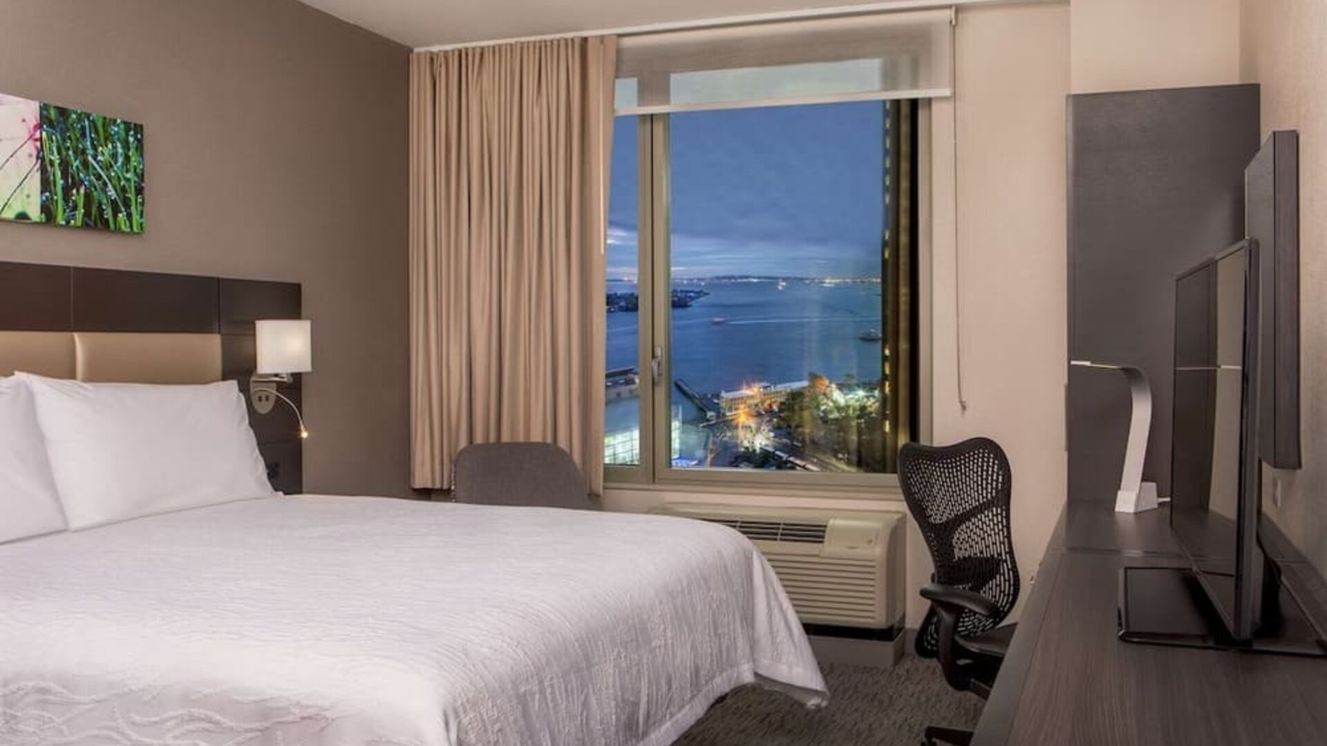 King bedroom with work station and city view at Hilton Garden Inn NYC Financial Center/Manhattan Downtown.
