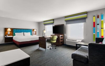 Spacious hotel suite with king size bed and working station at Hampton Inn & Suites Schererville.