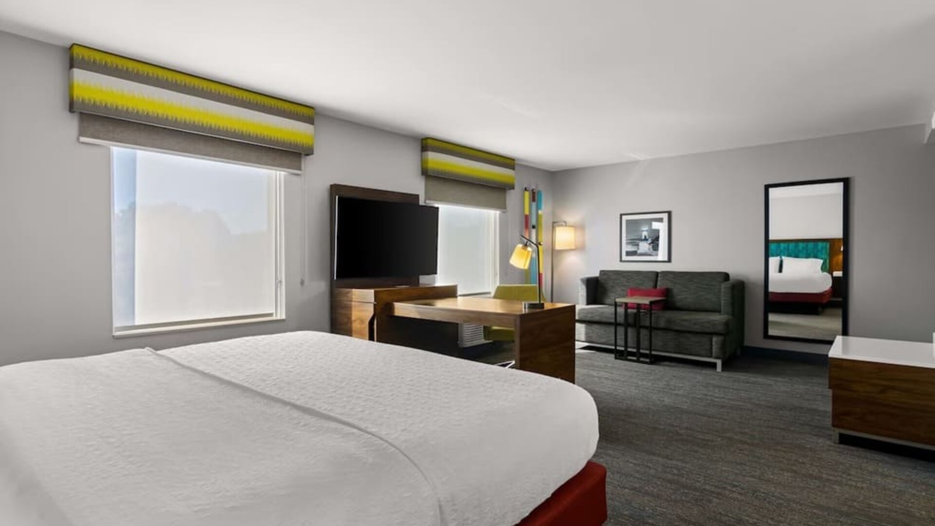 Spacious hotel suite with king size bed and working station at Hampton Inn & Suites Schererville.