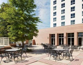 Outdoor seats available in the courtyard of the Hilton Charlotte Airport.
