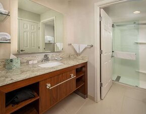 Private guest bathroom with shower and free toiletries at Sonesta ES Suites Baltimore BWI Airport.