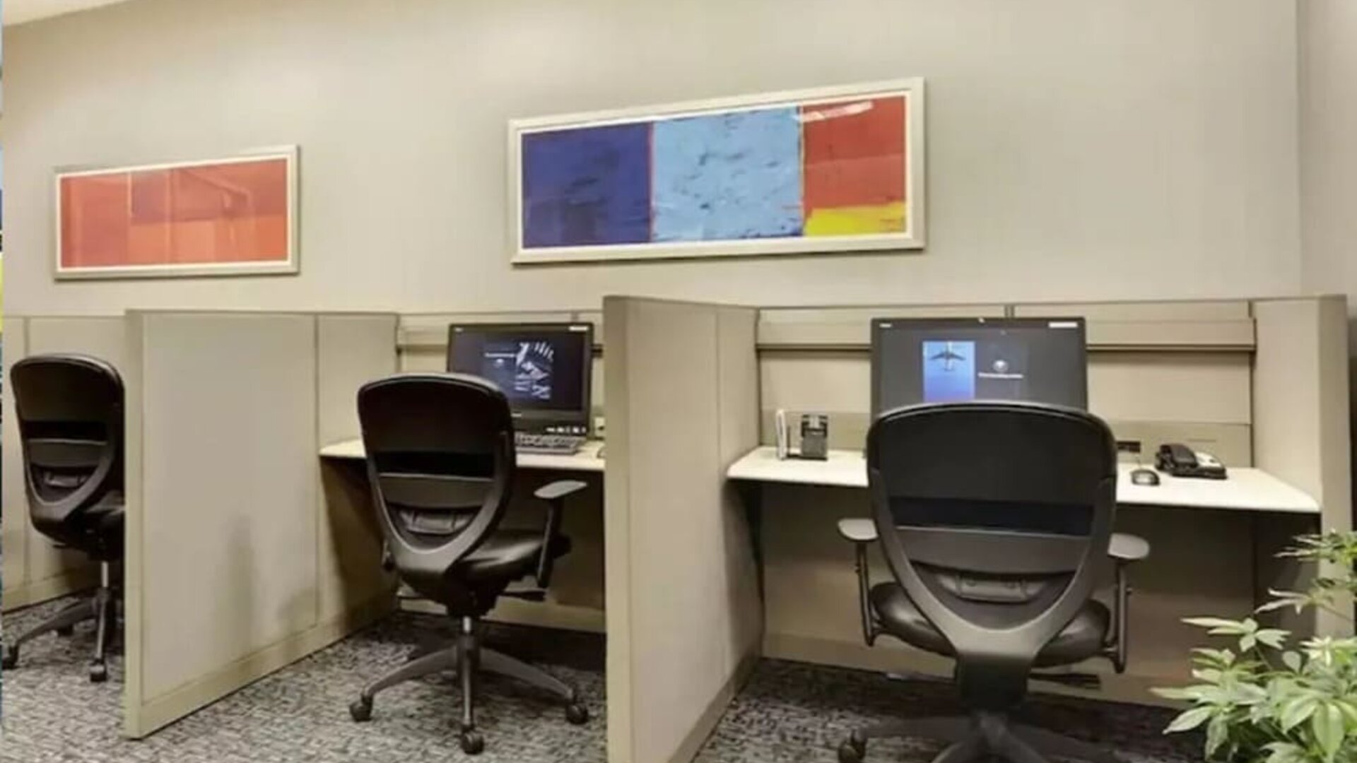Business center with computers, printer and ergonomic chairs at New York Hilton Midtown.