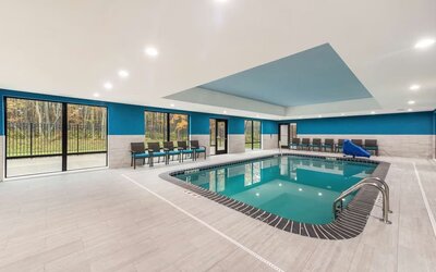 Relaxing indoor heated pool with lounge chairs at Hampton Inn & Suites Benton Harbor.