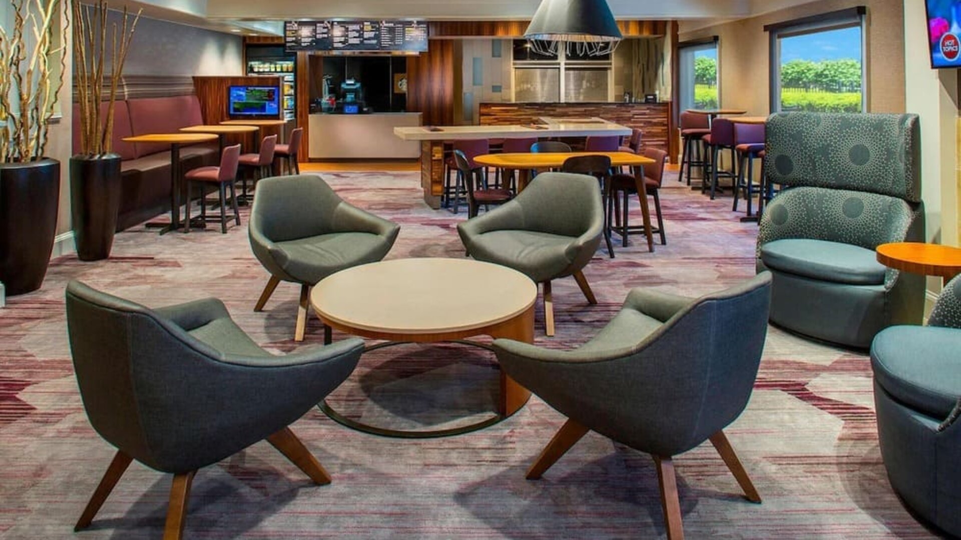 Lobby lounge area and workspace at Sonesta Select Boston Lowell Chelmsford.