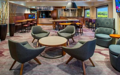 Lobby lounge area and workspace at Sonesta Select Boston Lowell Chelmsford.