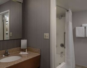 Private guest bathroom with shower and free toiletries at Sonesta Select Chattanooga Hamilton Place.