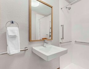 Private guest bathroom with shower and free toiletries at Sonesta Simply Suites Baltimore BWI Airport.