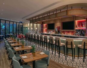 On-site bar with seating and lounge area at Sonesta Miami Airport.