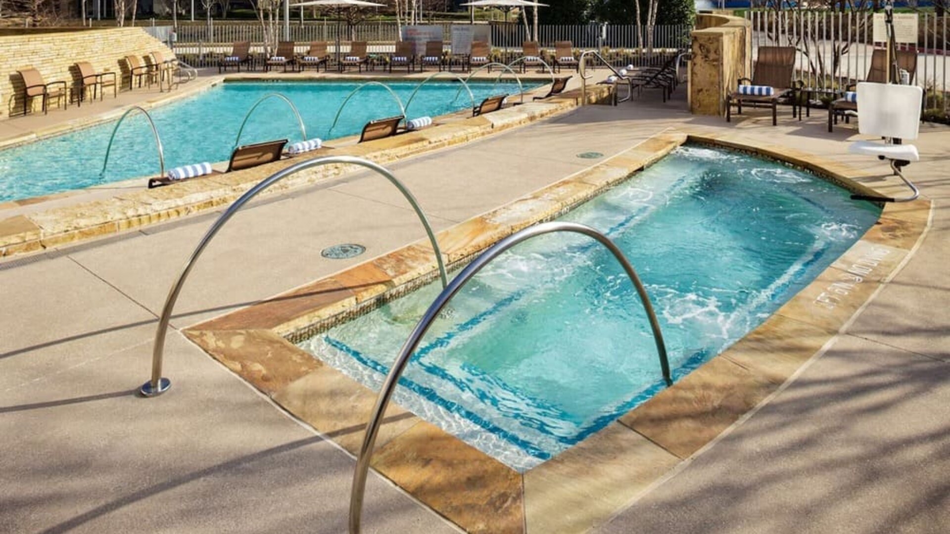 Refreshing outdoor pool and hot tub at Hilton Dallas/ Plano Granite Park.