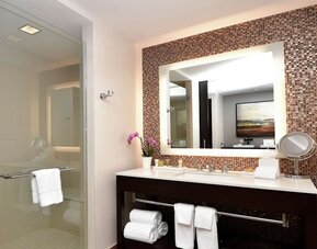 Guest bathroom with shower at Hilton Dallas/ Plano Granite Park.