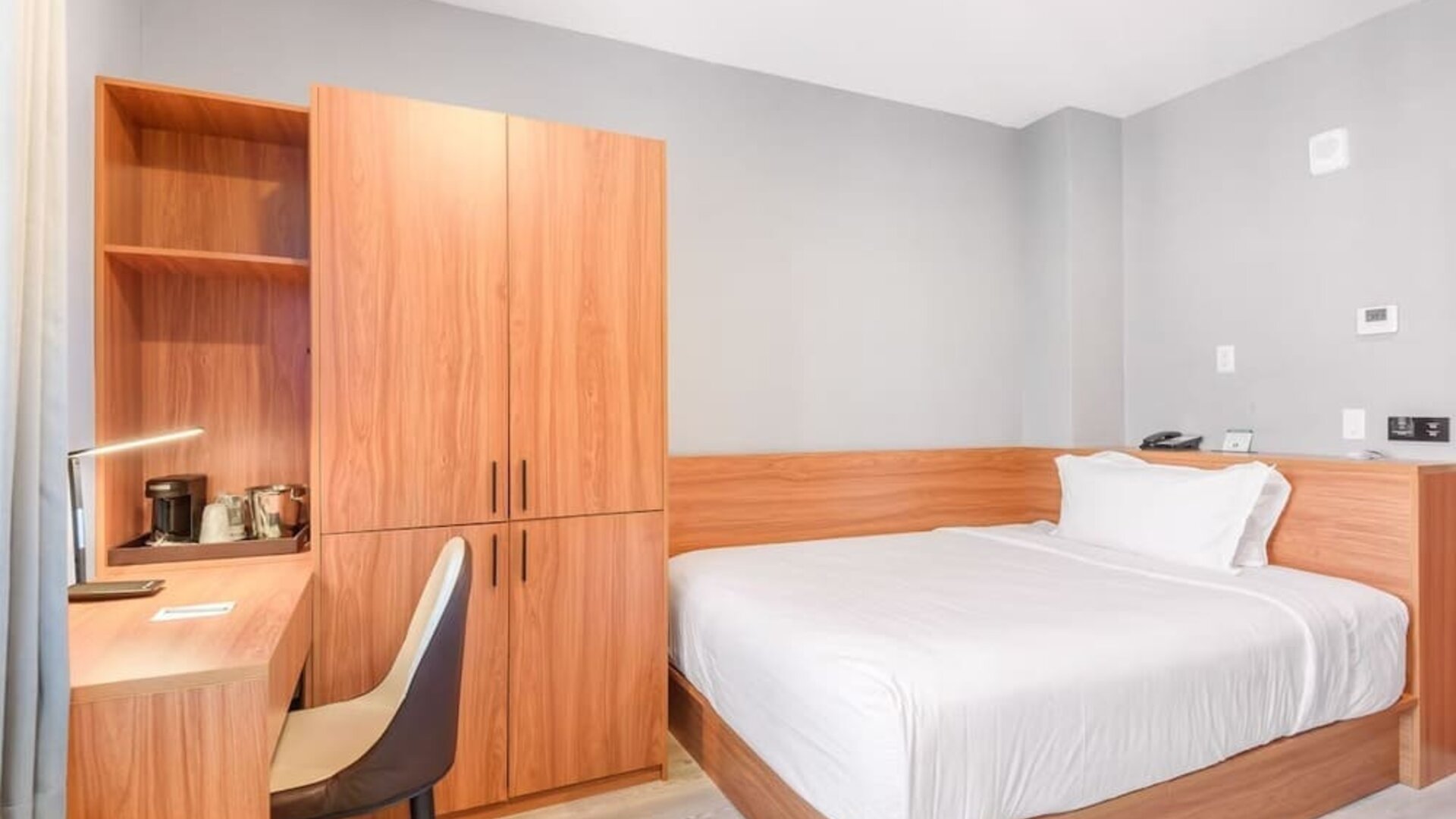 Day use room with work desk and natural light at Liberty View Brooklyn Hotel.