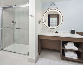 Guest bathroom with shower at The Chifley Houston, Tapestry Collection By Hilton.